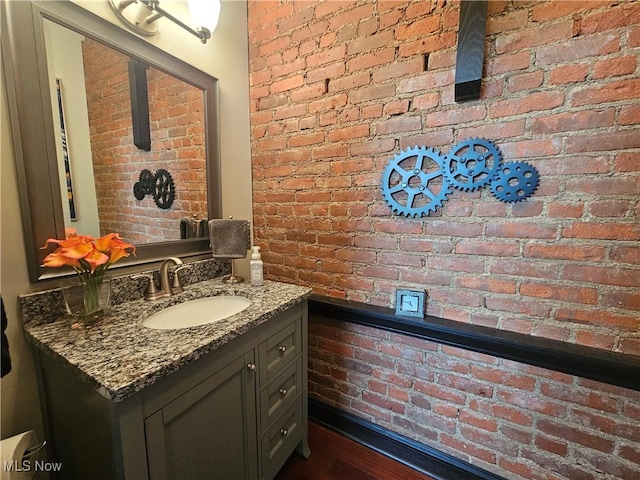 7482 Center St Unit 5, Mentor, OH 44060 - bathroom with brick wall, vanity, and wood finished floors