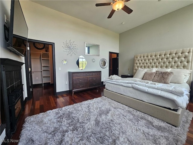 7482 Center St Unit 5, Mentor, OH 44060 - bedroom with wood finished floors, a fireplace, high vaulted ceiling, a ceiling fan, and a spacious closet