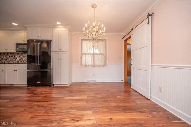 573 Grandview Ave, East Palestine, OH 44413 - kitchen featuring black appliances, a barn door, a chandelier, ornamental molding, and tasteful backsplash