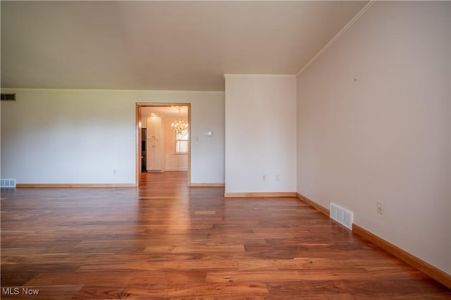 573 Grandview Ave, East Palestine, OH 44413 - spare room featuring a chandelier, crown molding, and wood finished floors