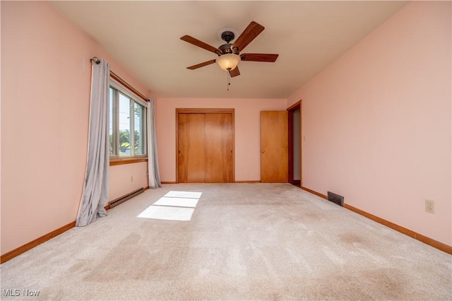 573 Grandview Ave, East Palestine, OH 44413 - unfurnished bedroom featuring carpet, baseboard heating, a closet, and a ceiling fan