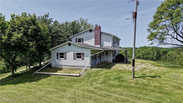 48846 Cain Ridge Rd, Clarington, OH 43915 - rear view of house featuring a chimney, a lawn, and a porch