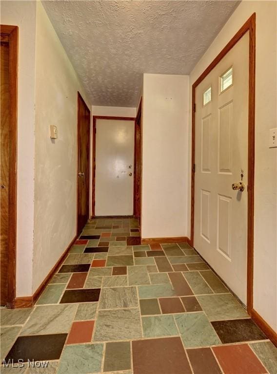 48846 Cain Ridge Rd, Clarington, OH 43915 - entrance foyer featuring stone finish floors and a textured ceiling