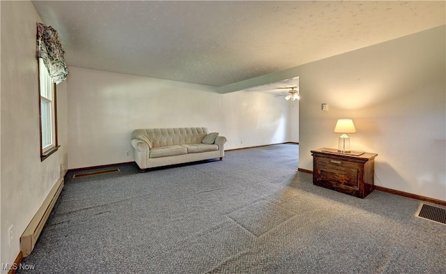 48846 Cain Ridge Rd, Clarington, OH 43915 - carpeted living area with a baseboard radiator and ceiling fan