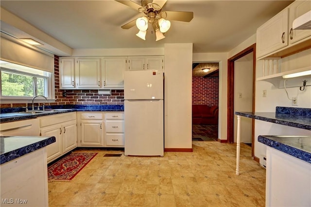 48846 Cain Ridge Rd, Clarington, OH 43915 - kitchen with freestanding refrigerator, a ceiling fan, dark countertops, open shelves, and white cabinetry