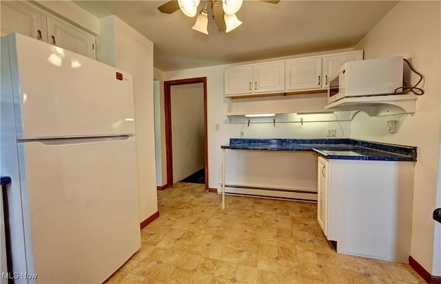 48846 Cain Ridge Rd, Clarington, OH 43915 - kitchen with freestanding refrigerator, a baseboard radiator, a ceiling fan, white cabinets, and dark countertops