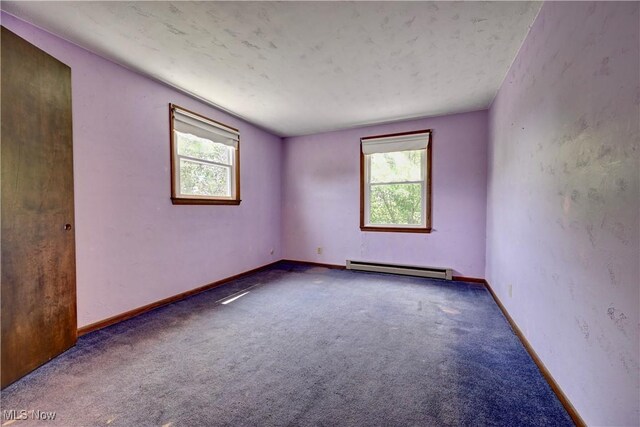 48846 Cain Ridge Rd, Clarington, OH 43915 - unfurnished room with healthy amount of natural light, a baseboard heating unit, and carpet