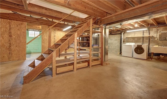 48846 Cain Ridge Rd, Clarington, OH 43915 - basement featuring washing machine and clothes dryer, stairway, and concrete block wall