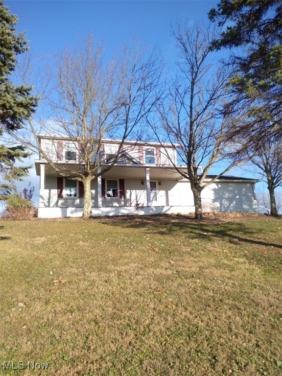 48846 Cain Ridge Rd, Clarington, OH 43915 - rear view of house with a porch, a lawn, and a garage