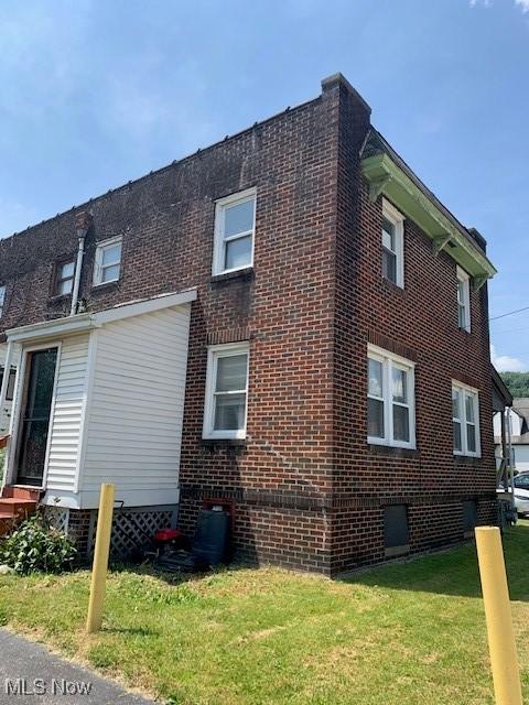 1212 N 4th St, Toronto, OH 43964 - view of side of property with a lawn and brick siding