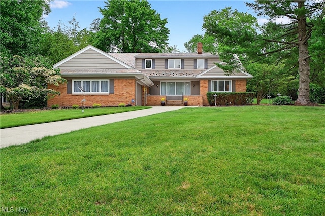 21349 Shelburne, Shaker Heights, OH 44122 - traditional-style house featuring a chimney, brick siding, a front yard, and driveway