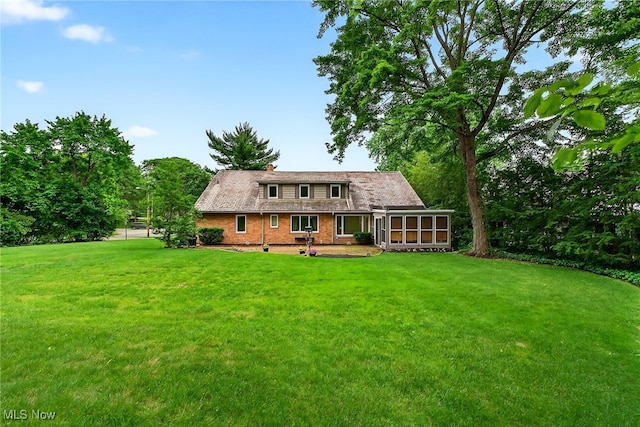 21349 Shelburne, Shaker Heights, OH 44122 - back of property with a sunroom, a yard, and brick siding