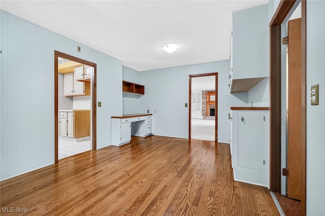 21349 Shelburne, Shaker Heights, OH 44122 - unfurnished living room featuring light wood-style floors, built in study area, and a fireplace