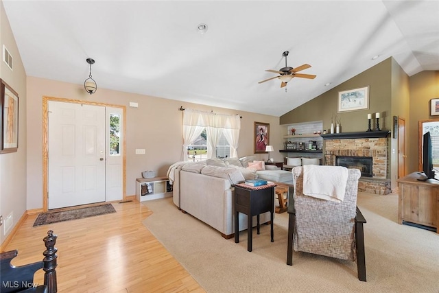 4568 Woodstone Ave NW, Massillon, OH 44647 - living area with a ceiling fan, wood finished floors, a fireplace, and high vaulted ceiling