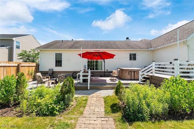 4568 Woodstone Ave NW, Massillon, OH 44647 - back of property with a hot tub, a wooden deck, and a shingled roof