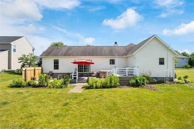 4568 Woodstone Ave NW, Massillon, OH 44647 - back of property with a wooden deck, a lawn, and a chimney