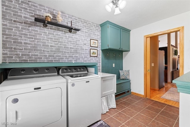 4568 Woodstone Ave NW, Massillon, OH 44647 - laundry area with washer and clothes dryer, cabinet space, and dark tile patterned flooring