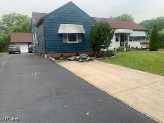 360 Tuxedo Ave, Brooklyn Heights, OH 44131 - view of front of house featuring a front yard and a garage