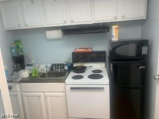 360 Tuxedo Ave, Brooklyn Heights, OH 44131 - kitchen with white electric stove, black microwave, ventilation hood, and white cabinets