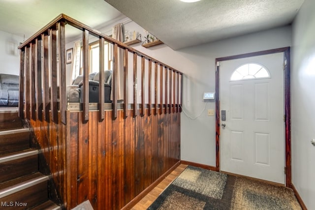 8998 Horn Rd, Windham, OH 44288 - entrance foyer featuring stairway and a textured ceiling