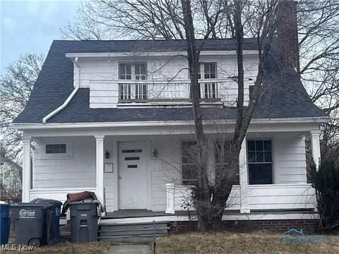 423 Oak St, Toledo, OH 43605 - view of front of property with a porch, a chimney, and a balcony