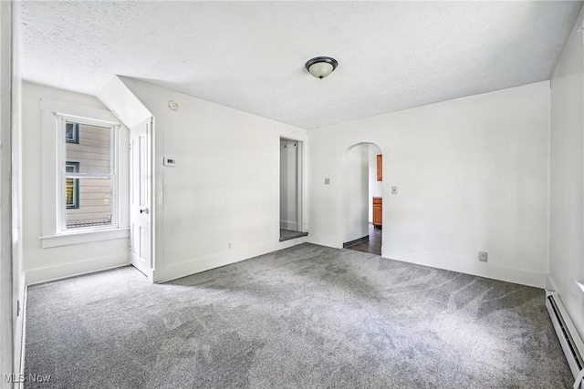 693 W Wilson St, Salem, OH 44460 - empty room with baseboard heating, arched walkways, carpet, and a textured ceiling