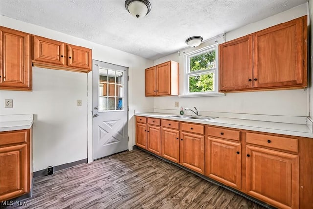 693 W Wilson St, Salem, OH 44460 - kitchen with dark wood-style flooring, a textured ceiling, brown cabinetry, and light countertops