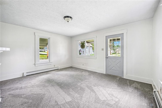 693 W Wilson St, Salem, OH 44460 - carpeted entrance foyer featuring a baseboard heating unit, healthy amount of natural light, and a textured ceiling