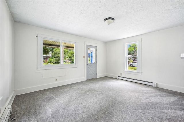 693 W Wilson St, Salem, OH 44460 - carpeted empty room featuring a baseboard heating unit and a textured ceiling