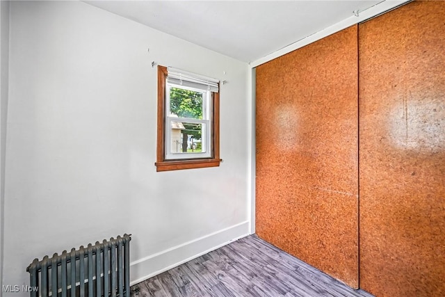 693 W Wilson St, Salem, OH 44460 - unfurnished room with radiator heating unit and wood finished floors