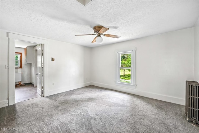 693 W Wilson St, Salem, OH 44460 - carpeted empty room featuring a ceiling fan, radiator heating unit, and a textured ceiling