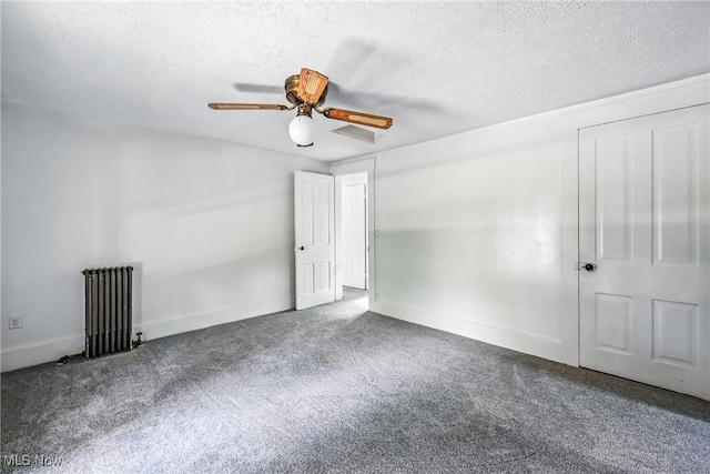 693 W Wilson St, Salem, OH 44460 - spare room with radiator heating unit, a textured ceiling, carpet, and a ceiling fan