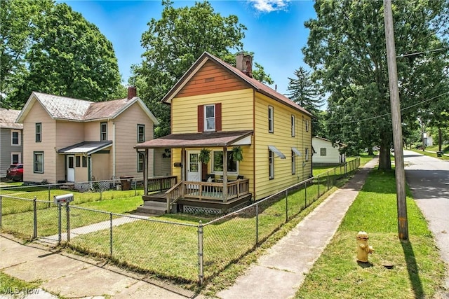 693 W Wilson St, Salem, OH 44460 - view of front of house featuring covered porch, a chimney, and a fenced front yard