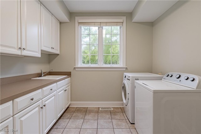 3925 Waterford Ct, Orange, OH 44122 - washroom featuring cabinet space, separate washer and dryer, and light tile patterned flooring