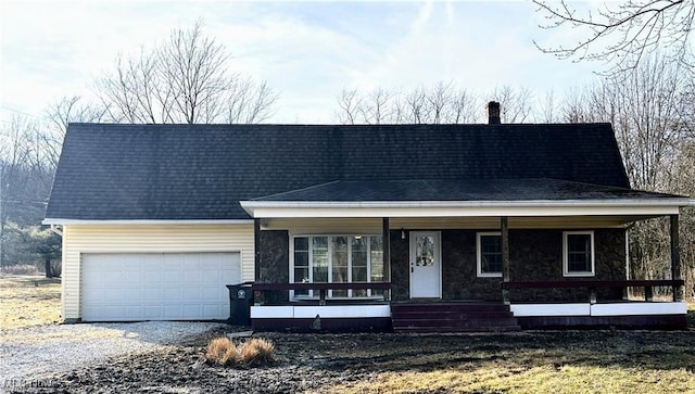 2511 Sherr Ave SE, Canton, OH 44707 - view of front facade with covered porch, a garage, driveway, stone siding, and a shingled roof
