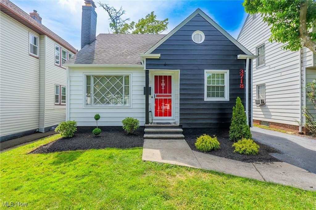 3718 Menlo Rd, Shaker Heights, OH 44120 - view of front of home with a front yard, a chimney, and roof with shingles