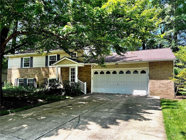 8001 Cherry Hl, Warren, OH 44484 - split level home featuring brick siding, driveway, and a garage