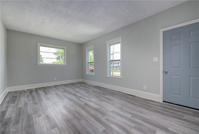 18104 Garden Blvd, Warrensville Heights, OH 44128 - empty room featuring wood finished floors and a textured ceiling