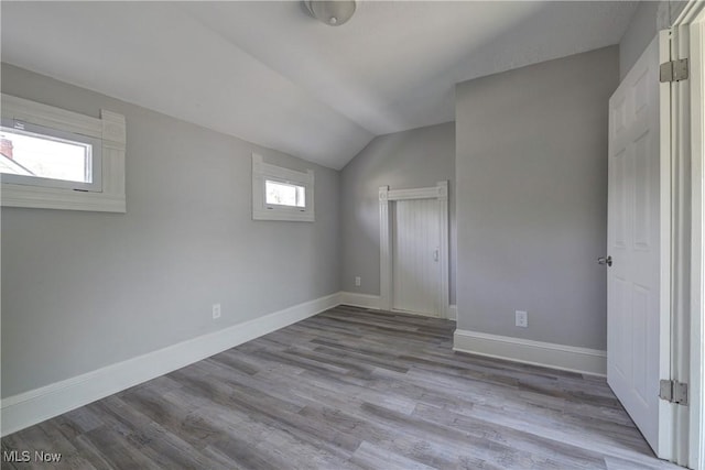 18104 Garden Blvd, Warrensville Heights, OH 44128 - unfurnished bedroom with vaulted ceiling and wood finished floors