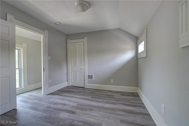 18104 Garden Blvd, Warrensville Heights, OH 44128 - empty room featuring wood finished floors and vaulted ceiling