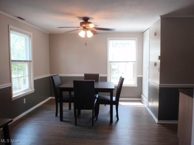 23 Valley Forge Ln, Elyria, OH 44035 - dining space with dark wood-type flooring, a ceiling fan, and crown molding