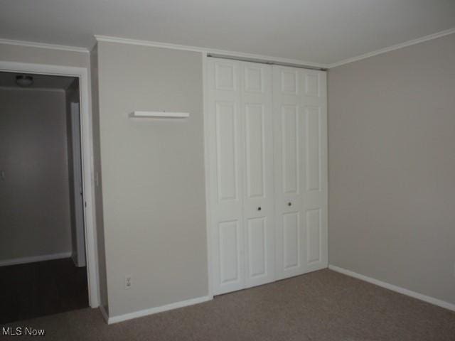 23 Valley Forge Ln, Elyria, OH 44035 - unfurnished bedroom featuring a closet, carpet, and ornamental molding