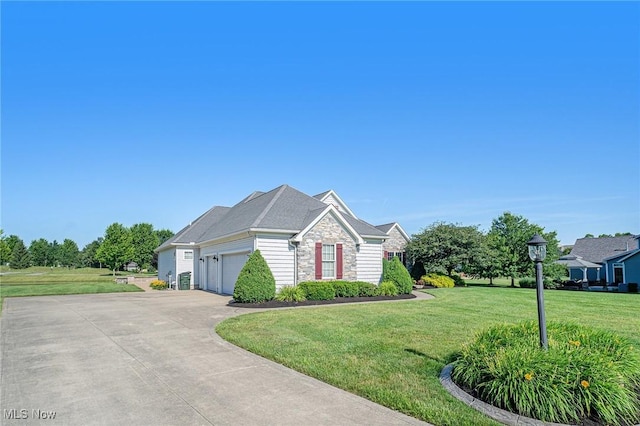 6782 Fawndale Dr, Medina, OH 44256 - view of front of house with stone siding, a front yard, concrete driveway, and an attached garage