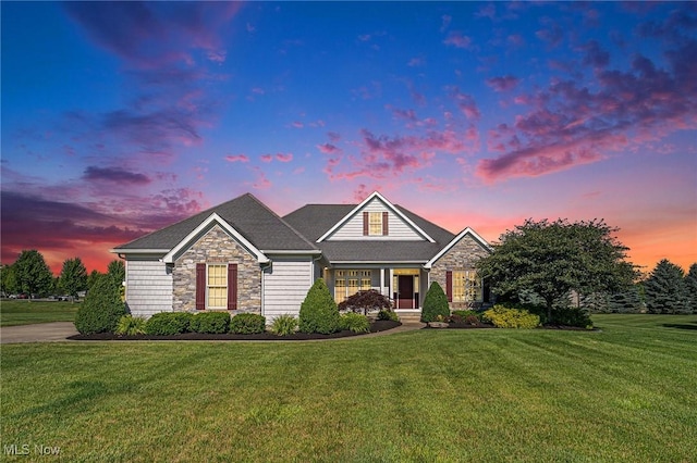 6782 Fawndale Dr, Medina, OH 44256 - view of front facade with stone siding, a lawn, and a porch
