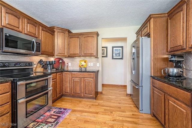 6782 Fawndale Dr, Medina, OH 44256 - kitchen featuring appliances with stainless steel finishes, brown cabinets, and a textured ceiling
