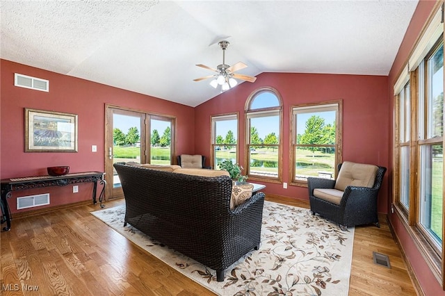 6782 Fawndale Dr, Medina, OH 44256 - living area featuring light wood-style flooring, vaulted ceiling, ceiling fan, and plenty of natural light
