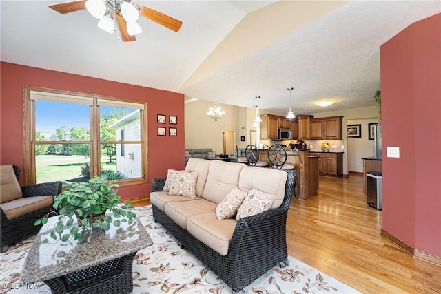 6782 Fawndale Dr, Medina, OH 44256 - living area with light wood finished floors, lofted ceiling, a chandelier, and ceiling fan