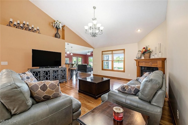 6782 Fawndale Dr, Medina, OH 44256 - living room with a chandelier, wood finished floors, high vaulted ceiling, and a fireplace