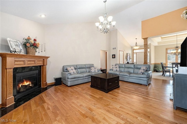 6782 Fawndale Dr, Medina, OH 44256 - living area featuring a chandelier, light wood finished floors, a premium fireplace, and a high ceiling