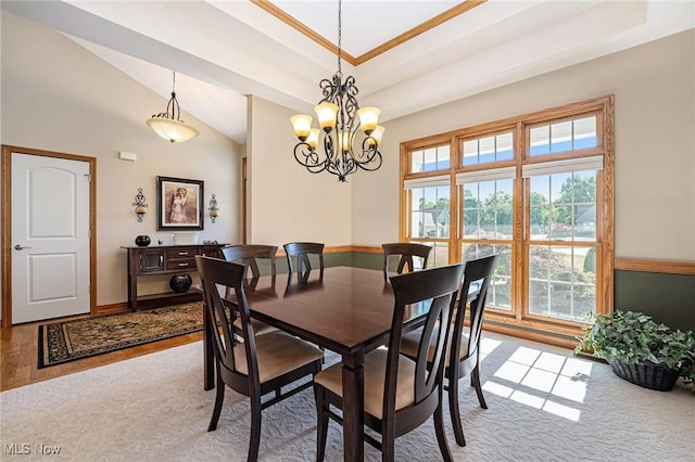 6782 Fawndale Dr, Medina, OH 44256 - dining space featuring a chandelier, vaulted ceiling, light wood-style flooring, and crown molding